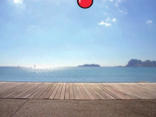 Er is een appel bovenaan op het scherm. De achtergrond is een kaai met zicht op zee.